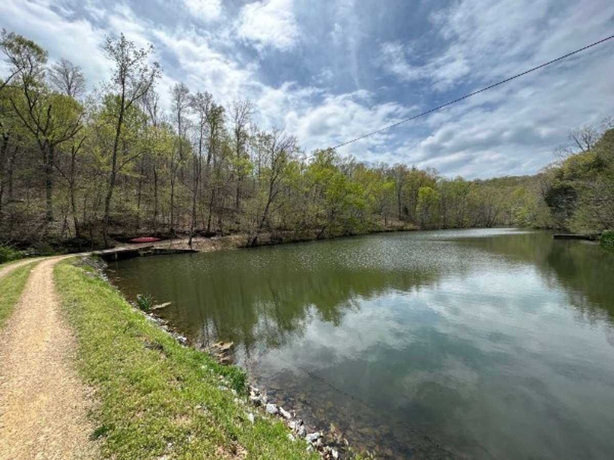 A gravel drive winds past a view of the lake and leads to several of the other cabins on the property, though each one is thoughtfully sited for exceptional privacy.