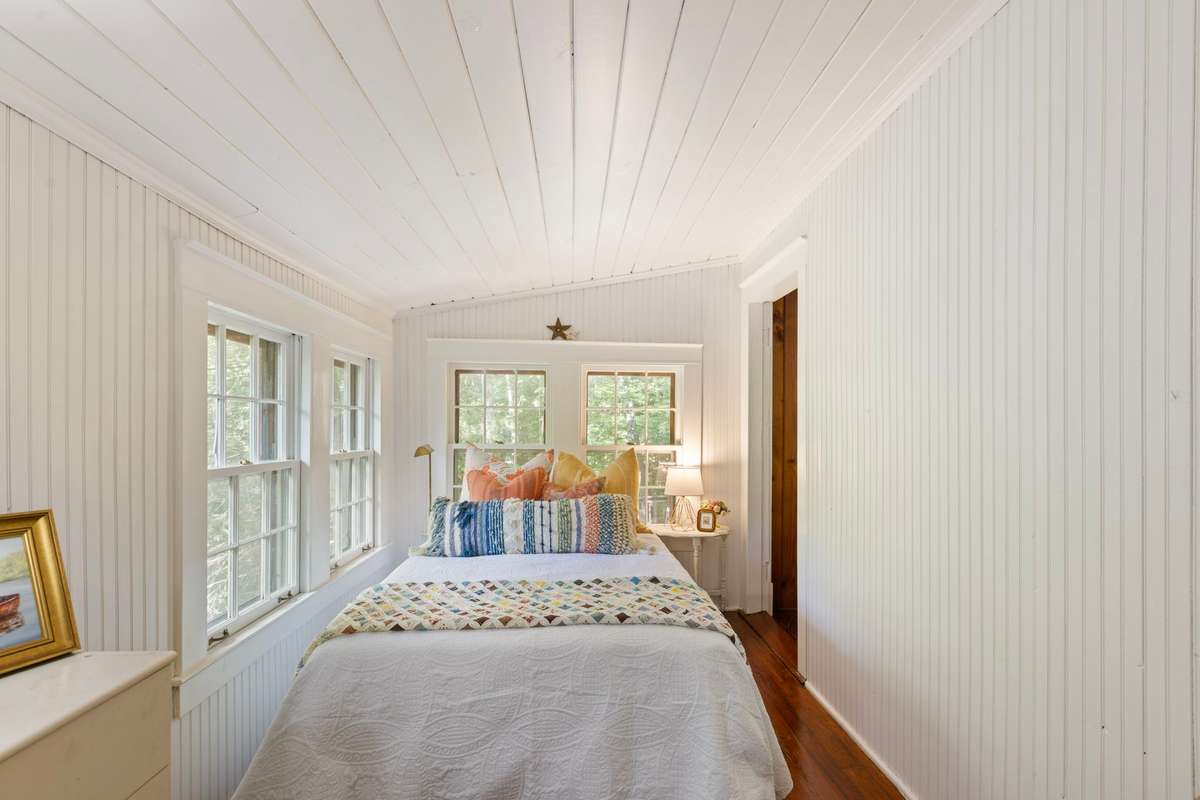 A charming bedroom in the treetops! There is room for a chest of drawers on each side wall.