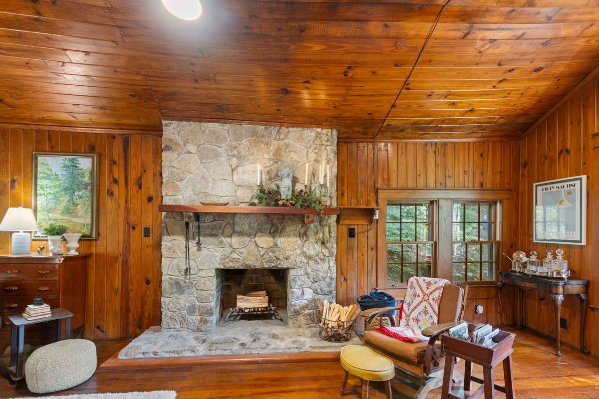 The stone stacked fireplace is wood burning. A stack of wood is waiting for you on the property.