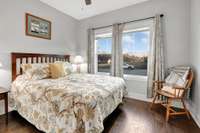 Bedroom three features large picture windows.