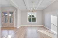 Formal dining room to the left of the entry has a coffered ceiling for gorgeous detail and dining in style!