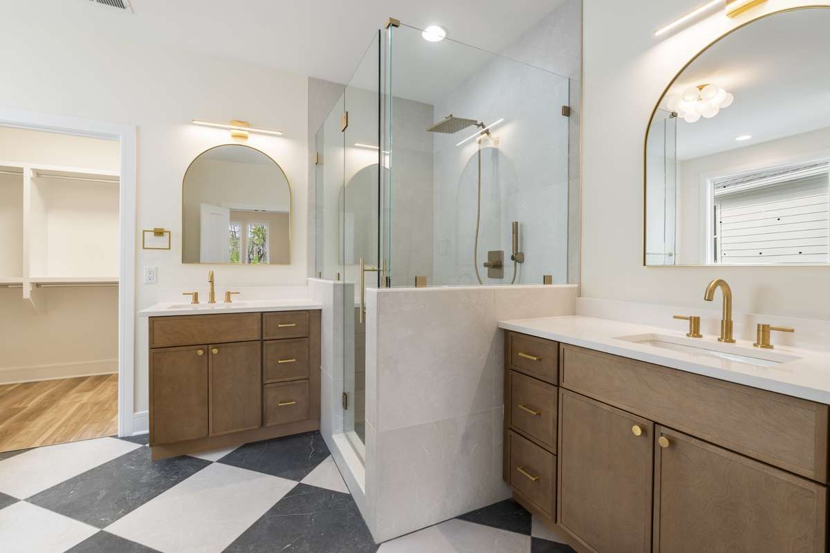 Primary bathroom with two vanities between one gorgeous shower