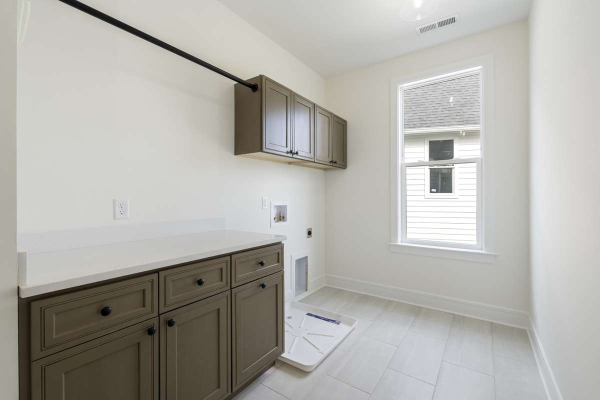 Large laundry room located on the second level at the top of the stairs