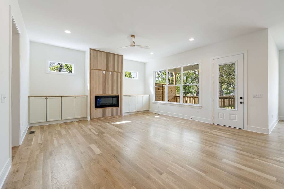 Living room with fireplace and door to covered patio  and the backyard