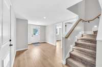Entry way in the basement with storage closet, storm shelter, and upgraded recessed lighting.