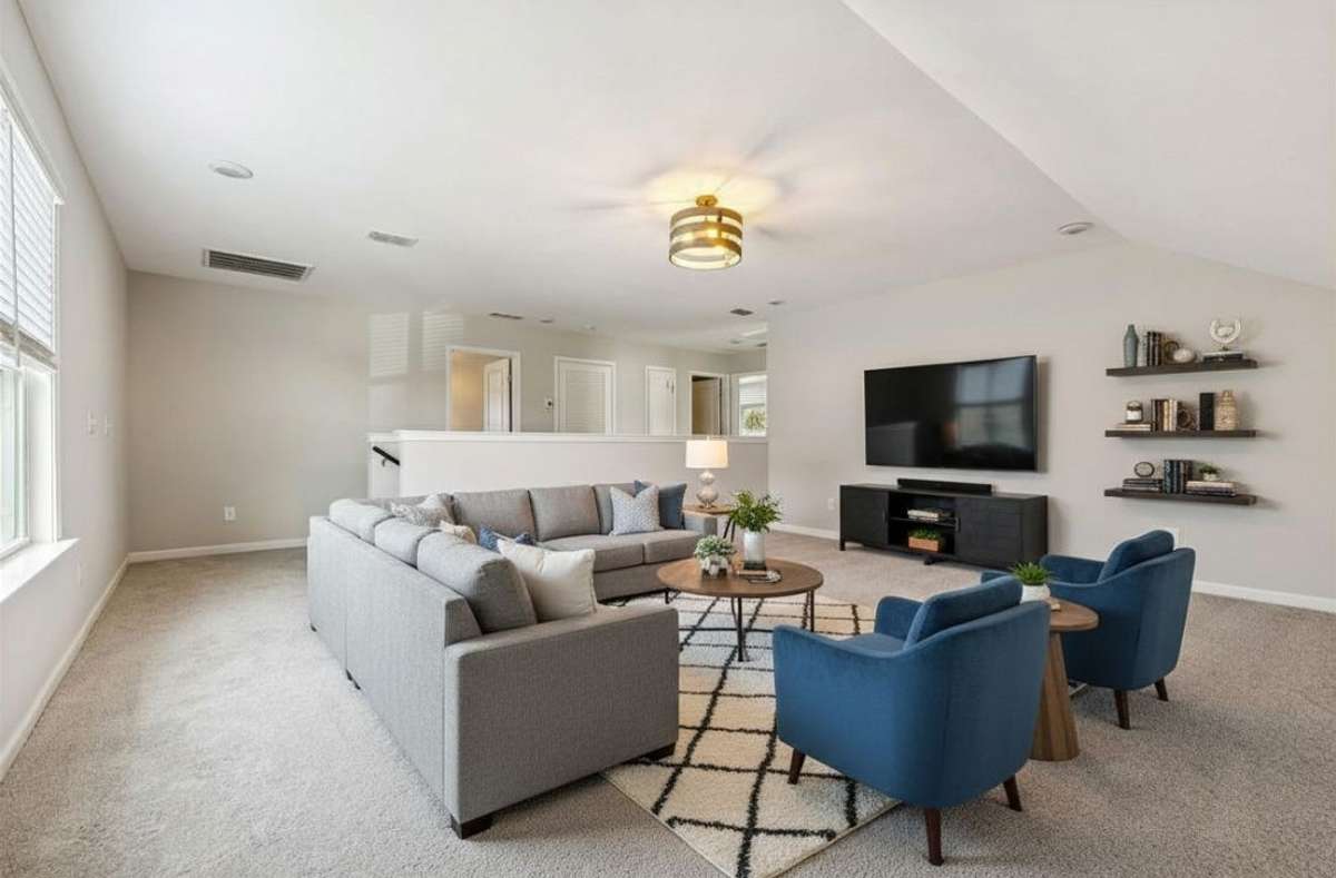 Large bonus room with carpet flooring, neutral color scheme & modern light fixture. 549 Montrose Dr. Mt. Juliet, TN 37122