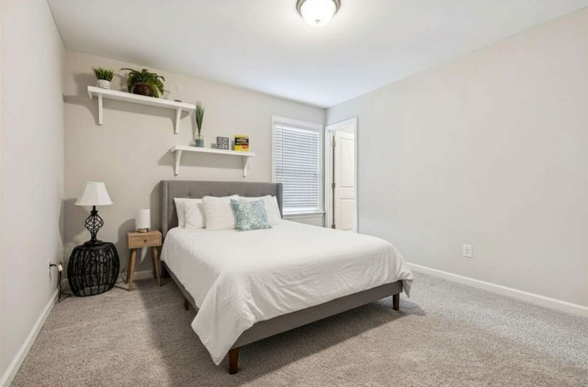 Third bedroom with neutral color tones, carpet flooring & window. 549 Montrose Dr. Mt. Juliet, TN 37122