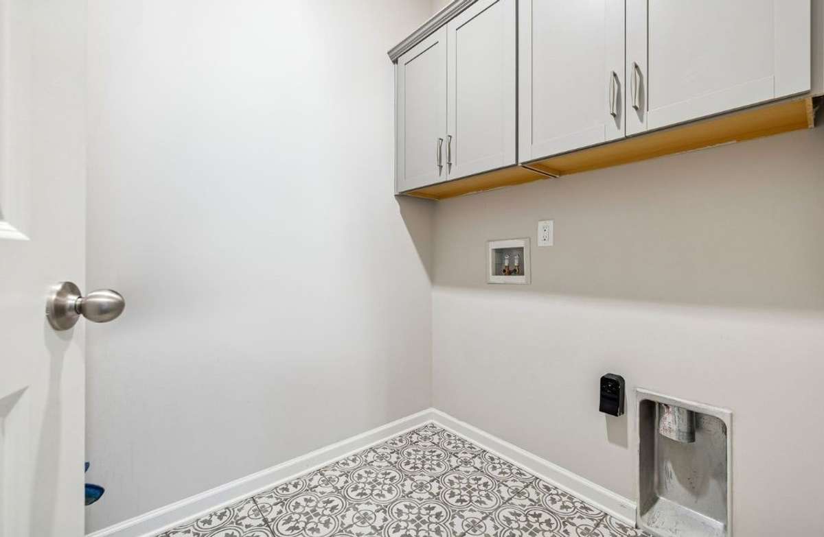 Utility room with built in cabinets & designer tile flooring. 549 Montrose Dr. Mt. Juliet, TN 37122