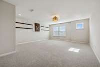 Large bonus room with several windows, unique light fixture & carpet flooring. 549 Montrose Dr. Mt. Juliet, TN 37122