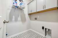Utility room with designed tile flooring & cabinet storage. 549 Montrose Dr. Mt. Juliet, TN 37122