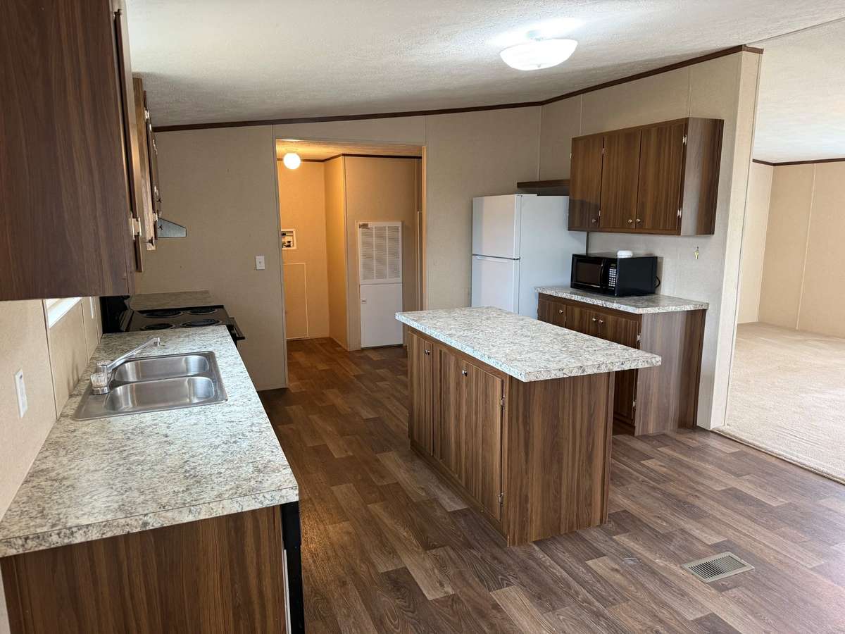 Kitchen- vinyl flooring, kitchen island, microwave, electric stove/oven, dishwasher, refrigerator