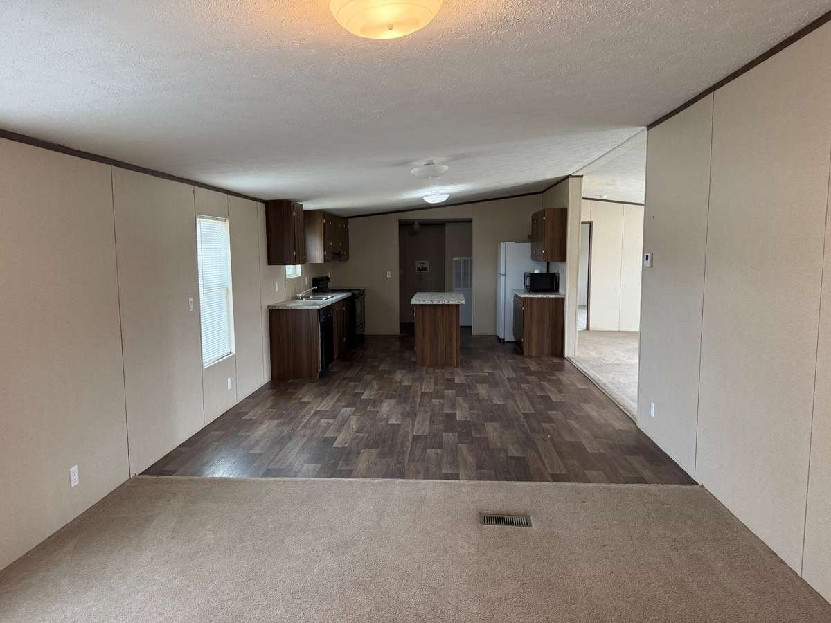 Kitchen- vinyl flooring, kitchen island, microwave, electric stove/oven, dishwasher, refrigerator
