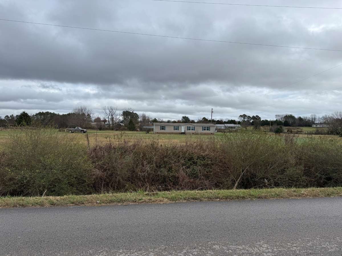 View from road- 2018 Southern Energy Mobile Home - vinyl siding on a permanent foundation, composition shingle roof, new gutters, gravel driveway