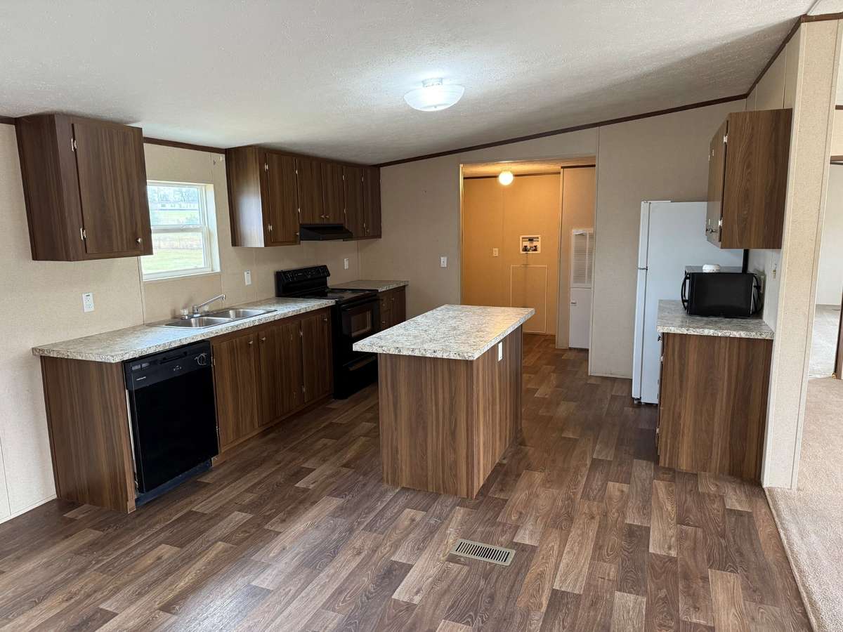 Kitchen- vinyl flooring, kitchen island, microwave, electric stove/oven, dishwasher, refrigerator