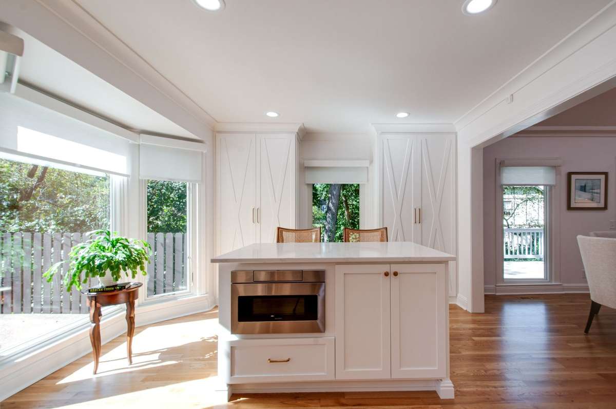 Another view of the stunning breakfast room. The island sits on the hardwood floors, so it can be replaced by a dining table to free up more living space in what is now used as open combination living and dining space.
