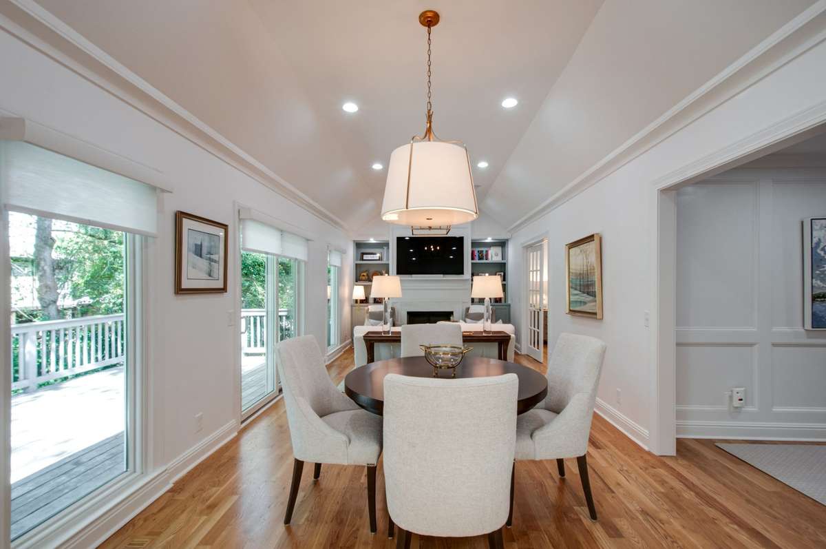 Spacious great room seamlessly combining living and dining areas under tall ceilings that create an airy, open feel.
