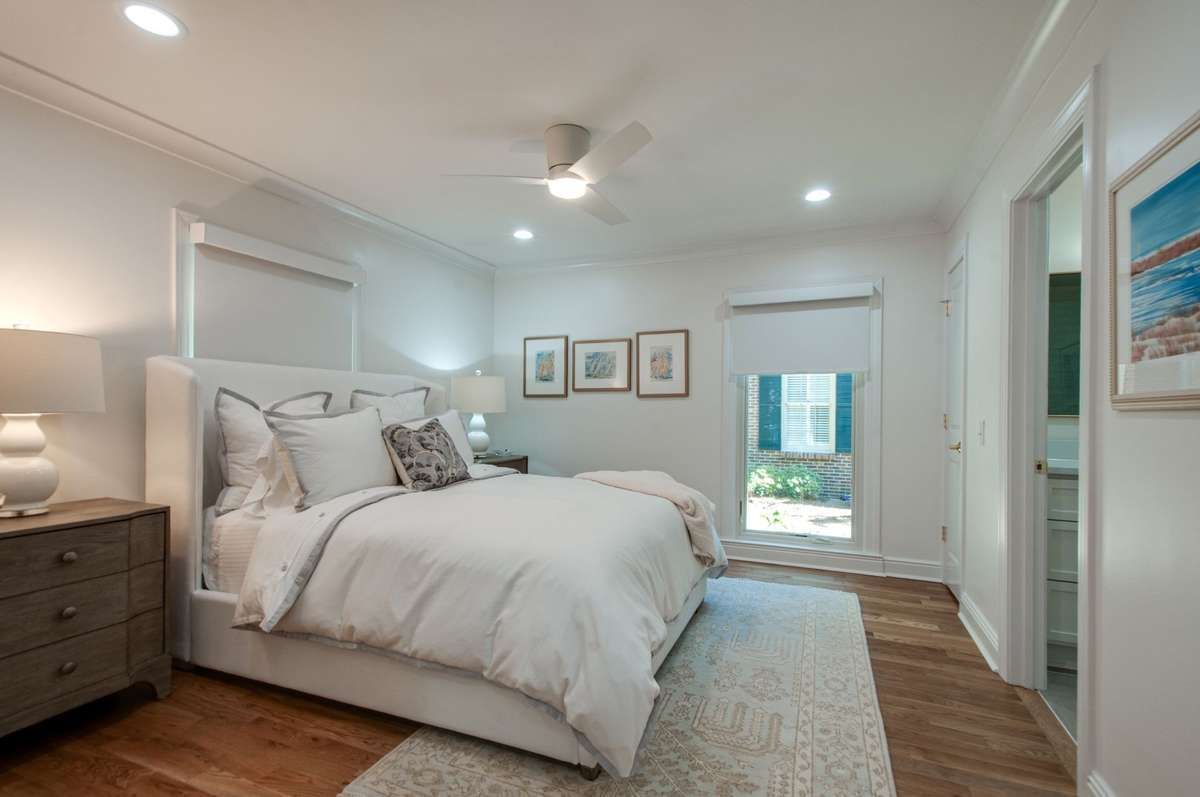The room has two large windows covered with custom blackout shades.