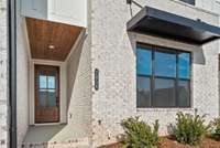 Covered Stoop w/ stained Tongue-and-Groove Ceiling w/ 8' Tall Stained Front Door