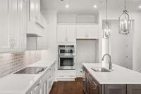 All Appliances are KitchenAid: Electric Cooktop, Built In Microwave & Wall Oven w/ Convection Bake and Air Fryer Mode. The Hood Vent is vented to the exterior as a standard feature in all townhomes.