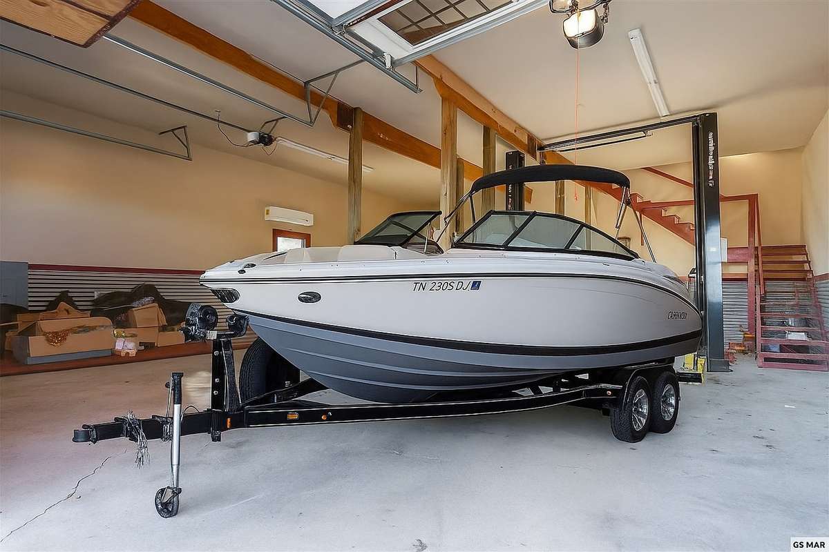 With 12.5 ft ceilings and 1,480 total sqft, the garage allows ample room for boat storage or an RV.  *This photo is staged and is used to show the possibility of boat and RV storage.