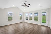 VAULTED family room ceiling with SO many windows to enjoy the view! Actual Photo of Home