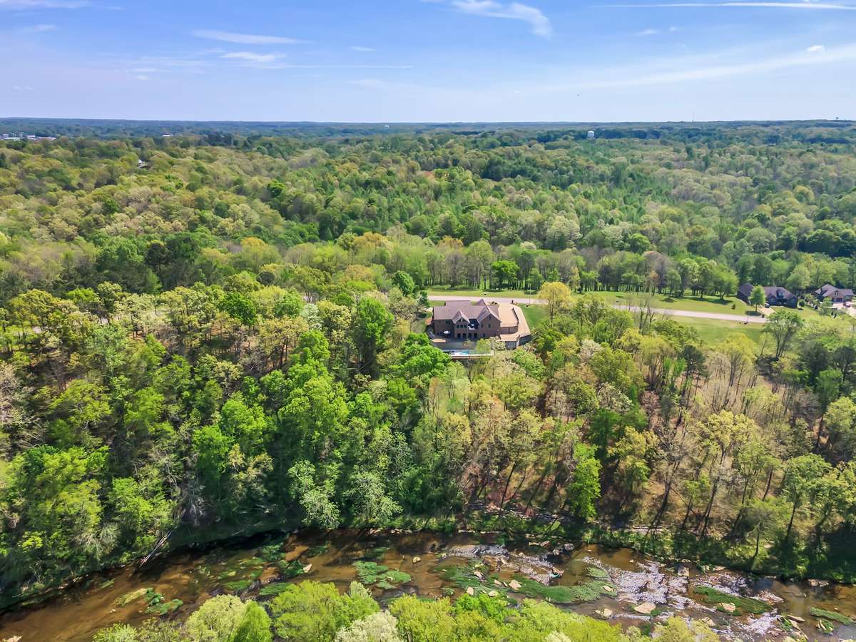 drone view of back of house with creek