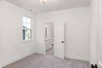 Your cozy third bedroom, where warmth and comfort create the perfect space. The room features a large walk-in closet for your belongings.