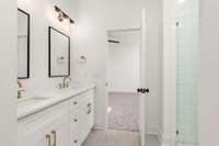 The attached primary en-suite bath boasts a luxurious walk-in shower, and dual vanities, offering a spa-like experience right at home.