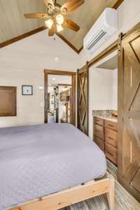 A built-in dresser is flanked by 2 closets on each side with sliding barn doors for the most optimal use of the space. The bedroom has a pocket door into the hallway so there are no battles of doors anywhere in this house!