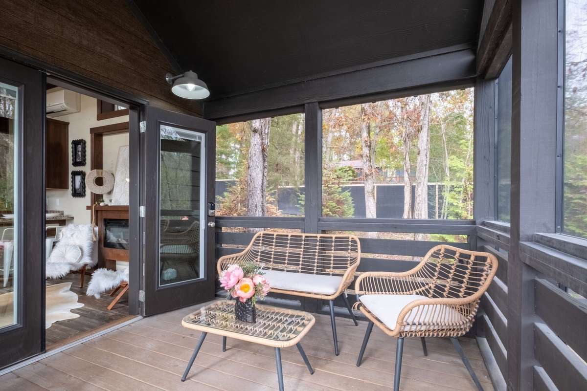 The screened-in porch has double glass doors into the living room drenching the home with natural light and allowing for great flow!