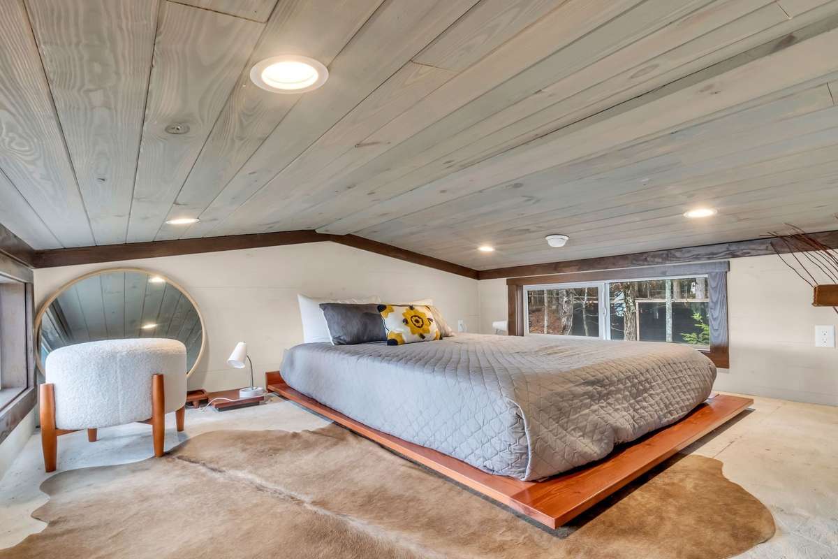The loft has a queen size platform bed and is just as charming and stylish as can be!