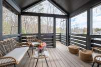 A lovely screened-in porch greets you as you come in the house