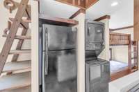The home is truly turnkey with a stacked washer/dryer and a refrigerator -- Love the brilliant use of the space!