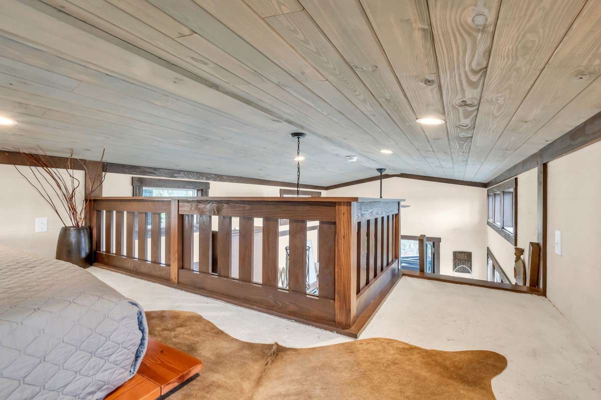 View from the loft into the house -- notice the detail of the wood boards on the ceiling.