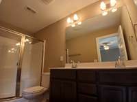 Primary Suite has Double Sinks and Cabinet Storage. 
Photo of Previous House.