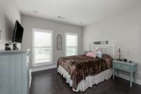2nd bedroom with plantation shutters, hardwood floors, and recessed lighting.