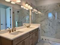Primary Bathroom w/ Large Walk In Shower and Bench Seating