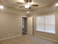 The primary bedroom has detailed tray ceilings, and a large closet for your belongings