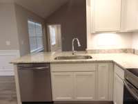 This kitchen is perfect for you to cook all your favorite dishes, the kitchen comes with steel appliances, crown cabinetry, under cabinet lighting, and plenty of cabinets for you to store all your goods.