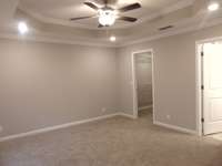 The primary bedroom has detailed tray ceilings, and a large closet for your belongings