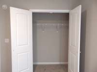 The second bedroom with a nice closet, and a lovely window for that natural light to come in.