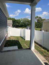 covered porch with included partial side yard fence. NOT ACTUAL HOME