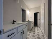 Master bath with split vanities.  Tile floor and Tile Shower with Bench included.