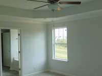 Owners Suite with Tray Ceiling and ceiling fan
