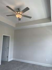 Master suite with trey ceiling and ceiling fan included