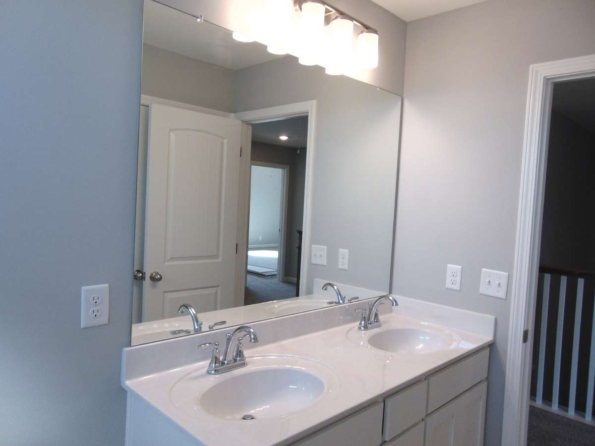 The second bath is a tub shower combo, includes two sleek sinks, as well as an elongated toilet, an elongated toilet, and plenty of cabinet space.