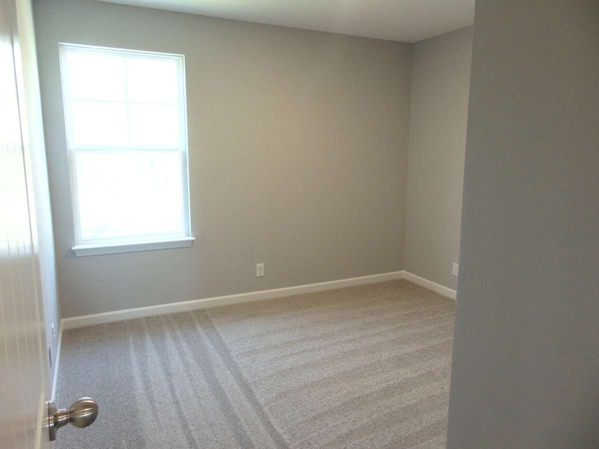 The third  bedroom with large windows for that nature lighting, as well as your closet with a convenient rack.