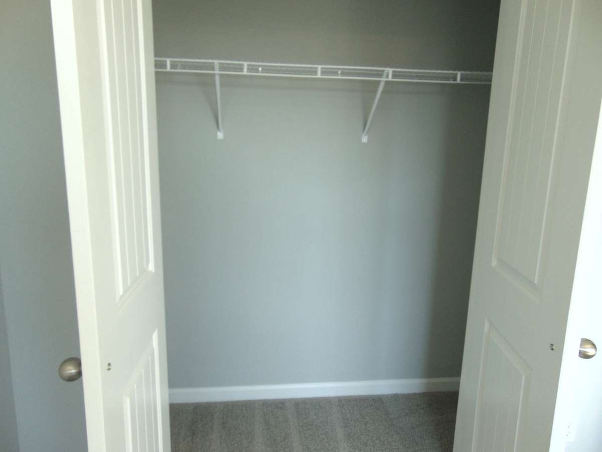 The second bedroom with large windows for that nature lighting, as well as your closet as well as a convenient rack.