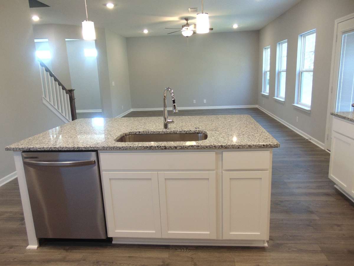The kitchen where you can cook all your specialty dishes with love. This kitchen has under cabinet lights, included steel appliances, as well as a modern and large island and sink.
