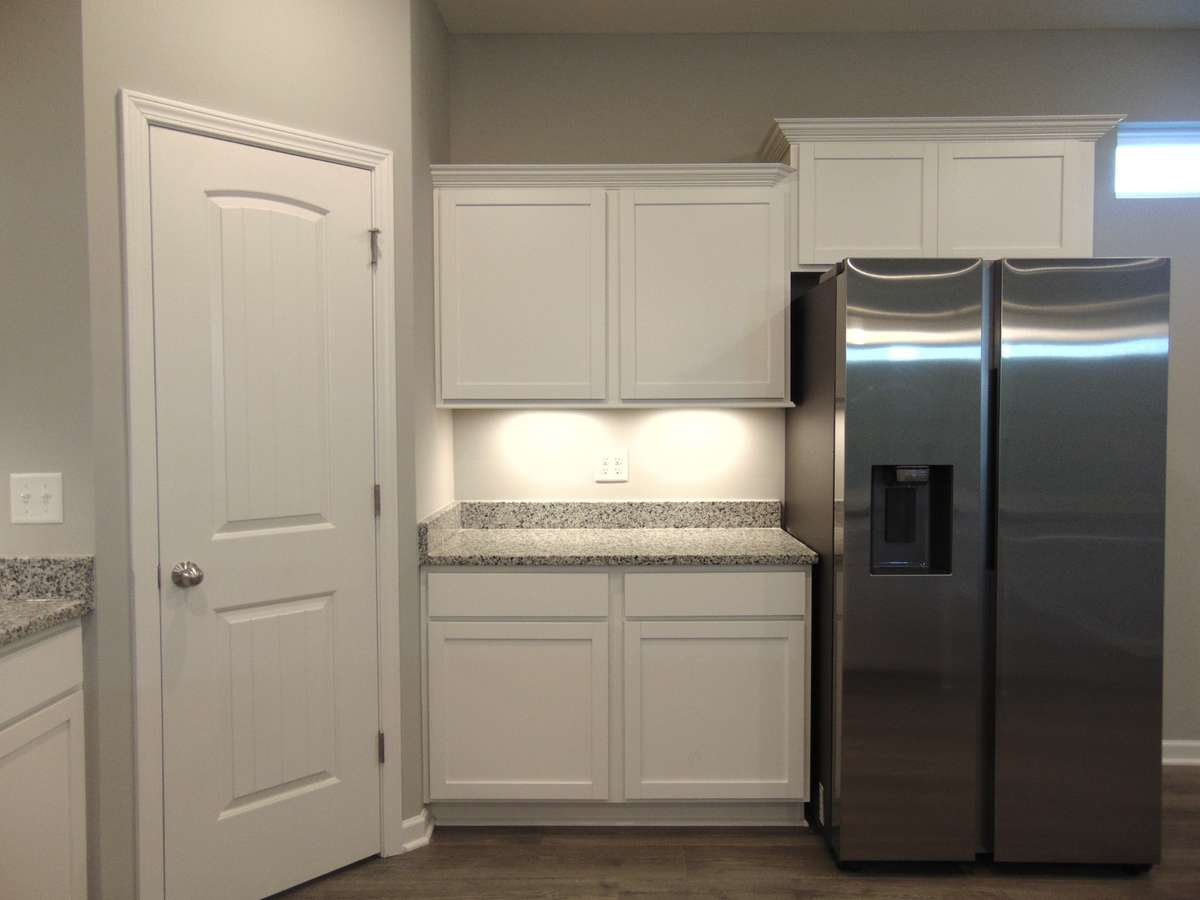 The kitchen where you can cook all your specialty dishes with love. This kitchen has under cabinet lights, included steel appliances, as well as a modern and large island and sink.